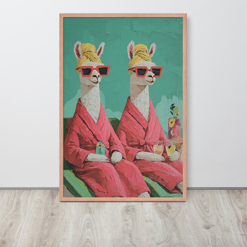 Alpaca bathroom wall art print featuring two llama figures in pink robes and red sunglasses sitting on a teal background, displayed against a light gray wall on a light wood floor.