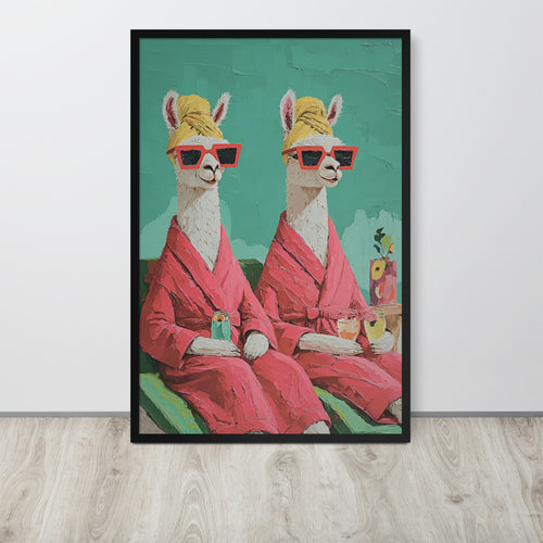 Funny alpaca wall art print featuring a whimsical painting of two llamas wearing pink robes, yellow head wraps, and red sunglasses against a teal background, displayed on a light wood floor against a white wall.