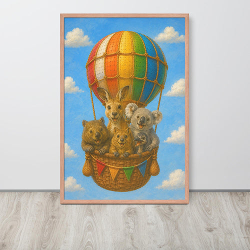 A framed nursery wall art print depicting a whimsical scene of kangaroos, a koala, and a wombat sitting in a wicker basket on a hot air balloon against a blue sky with clouds. The print is housed in a light natural wood frame and is shown leaning against a white wall on a light gray wood floor.