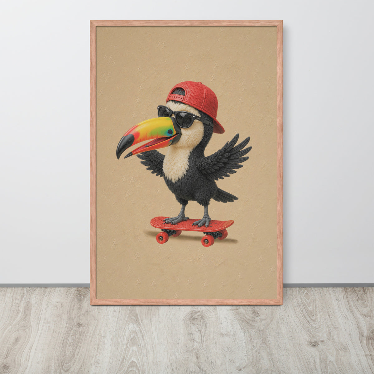 A framed jungle nursery wall art print featuring a cartoon toucan wearing a red baseball cap and black sunglasses while riding a red skateboard, displayed against a light gray wall on a light wood floor.