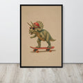 Triceratops dinosaur nursery wall art print featuring a cute green Triceratops dinosaur wearing a red cap and sunglasses while riding a red skateboard, displayed on a light wood floor against a white wall.