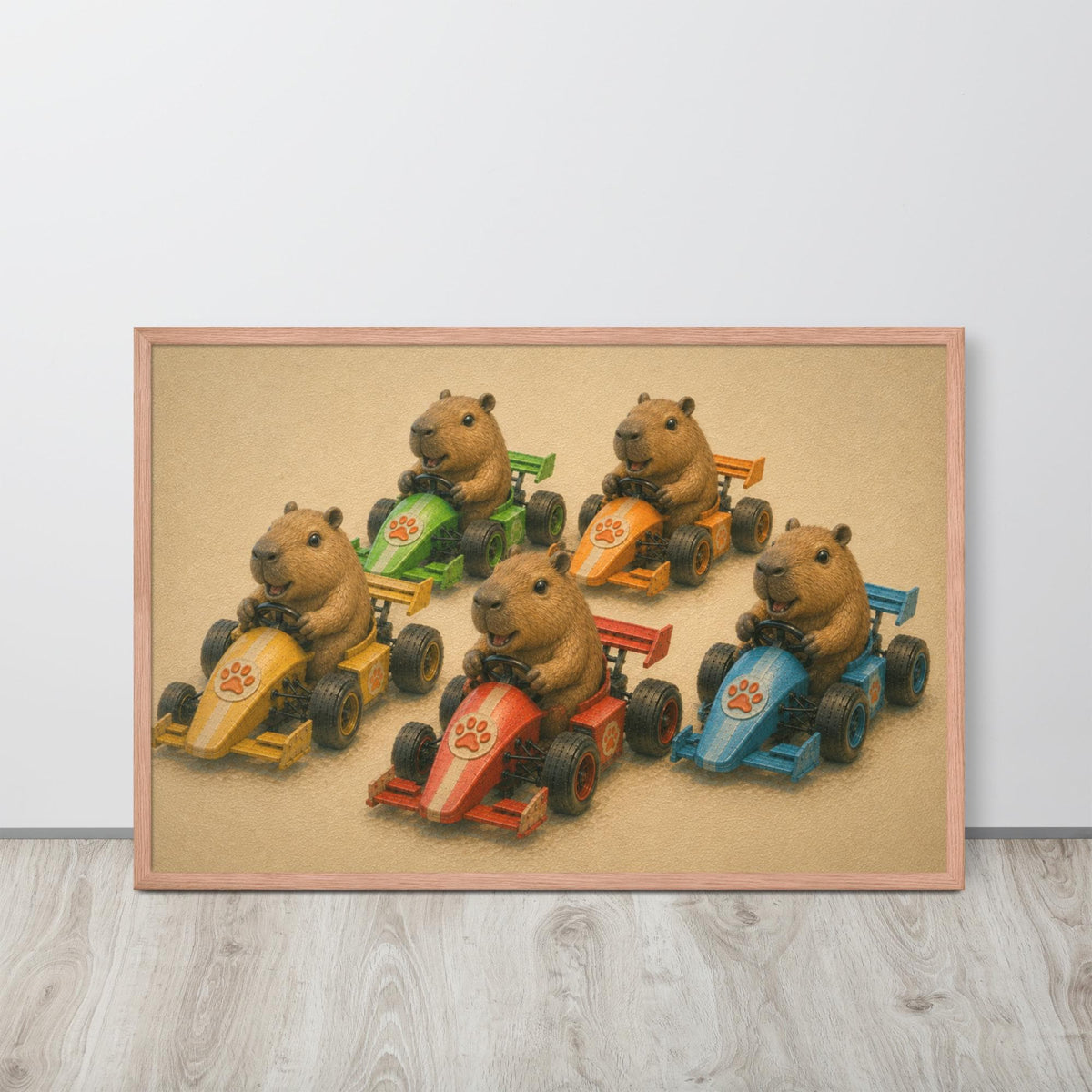 A framed F1 nursery wall art print featuring five capybara cartoon characters driving colorful race cars, displayed on a light gray wall above a light wood floor.