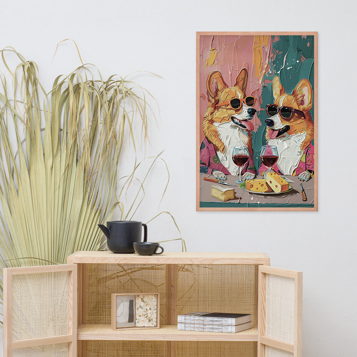 Corgi dog wine bar art print featuring two corgi dogs in sunglasses drinking wine and eating cheese, displayed on a light gray wall above a wooden shelf with decorative items.