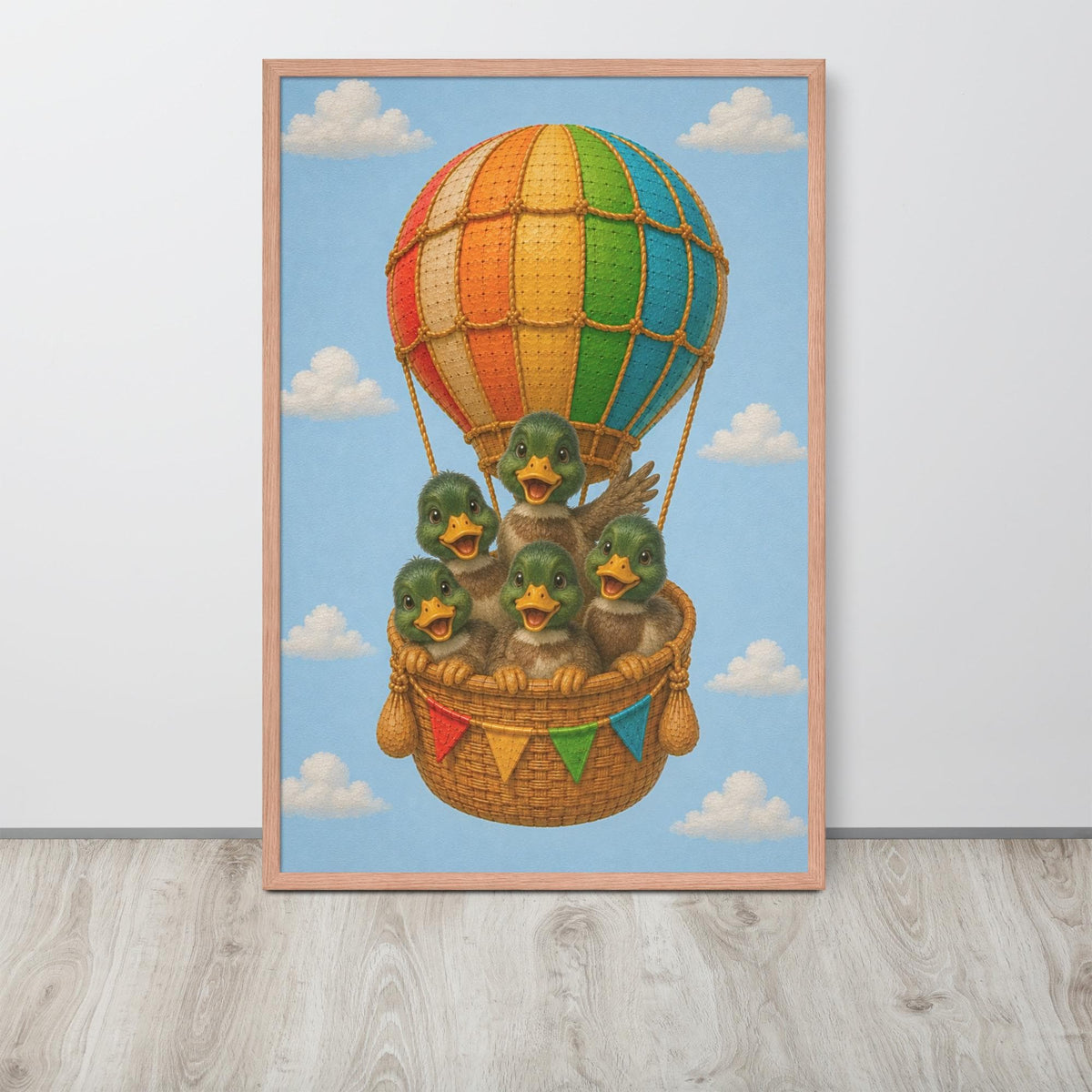 A framed mallard duck nursery wall art print featuring a whimsical illustration of five green ducks sitting in a wicker basket beneath a large rainbow-striped hot air balloon, set against a light blue sky with white clouds.