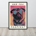 Pop art style washroom loo poster leaning against a light wall on a wood floor. The poster shows a pug wearing pink sunglasses with the text 'ARE YOU POOPING?' in black lettering on a cream background.