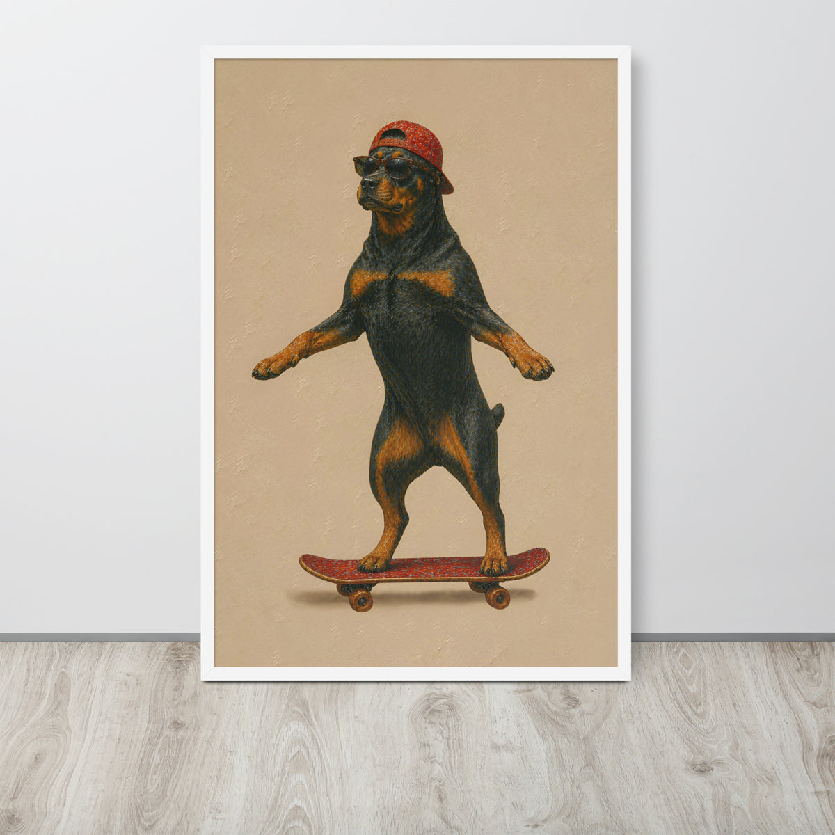 Cute Rottweiler wall art print featuring a vintage-style illustration of a Rottweiler dog balancing on a skateboard while wearing a red cap, displayed against a light gray wall on a light wood floor.