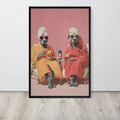 Staffy wall art print featuring two staffy dogs dressed in colourful robes and towels, leaning against a white wall on a light wood floor.