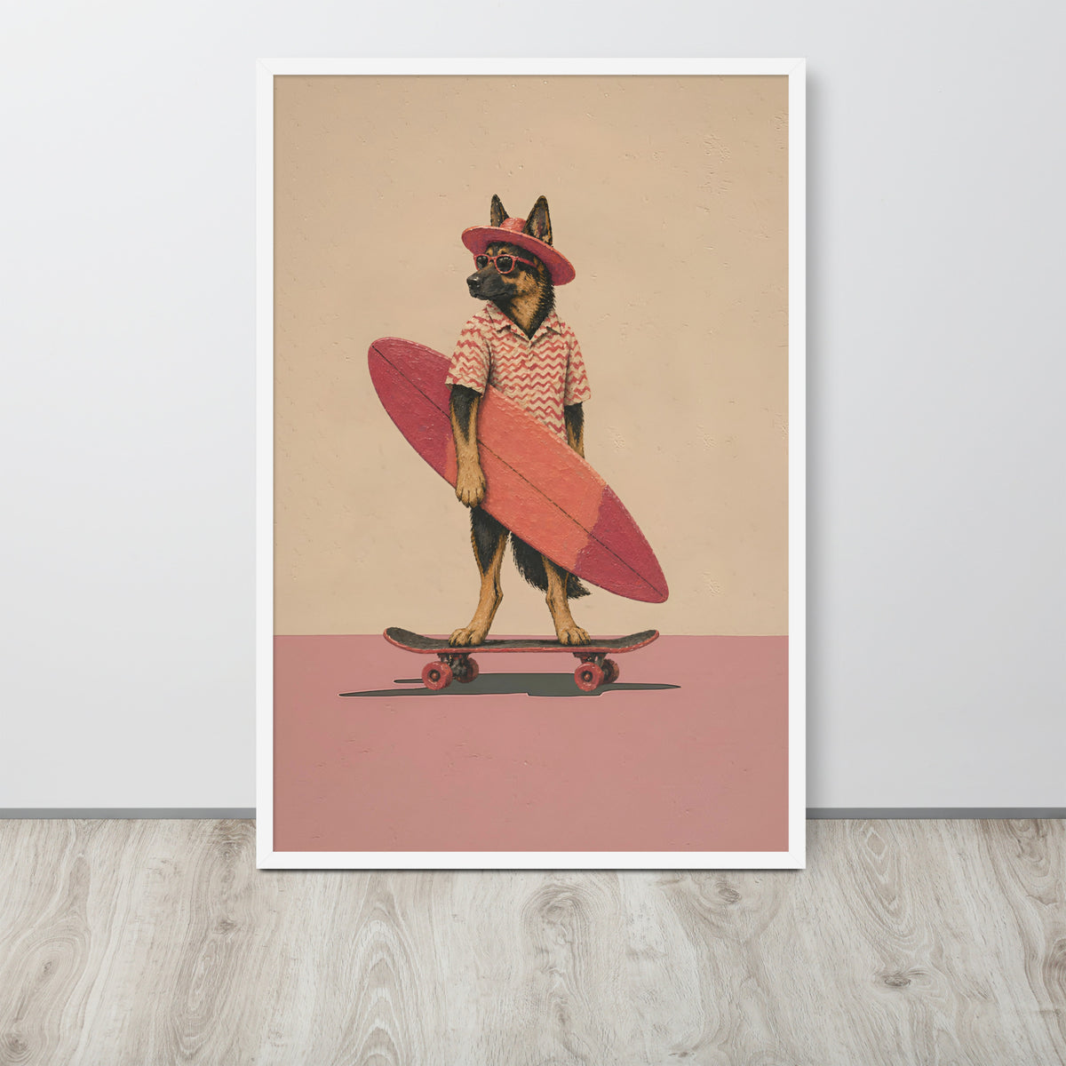 Retro German shepherd wall art print featuring a German Shepherd dog dressed as a surfer with a pink hat, patterned shirt, and pink surfboard, standing on a skateboard against a beige and dusty pink background. The print is displayed leaning against a light gray wall on a light wood floor.