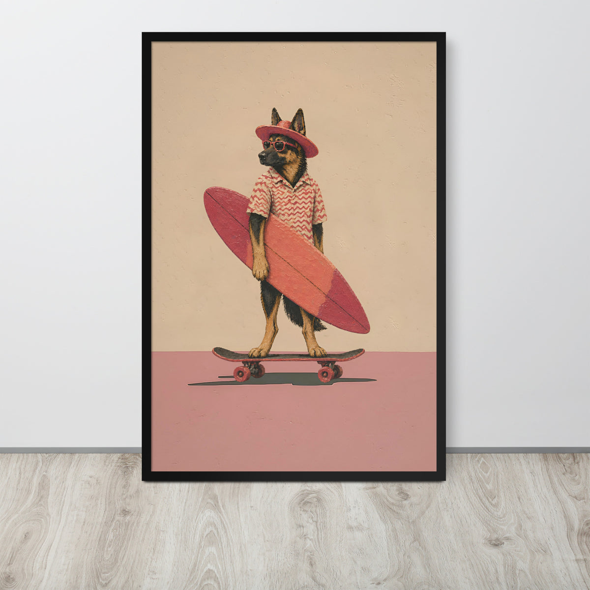 German shepherd wall art print leaning against a white wall on a light wood floor. The artwork shows a German shepherd dog dressed as a surfer, holding a pink surfboard on a skateboard, with a beige background and pink lower section.