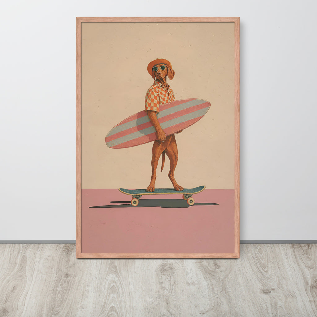 Vizsla dog wall art print featuring a stylized brown vizsla dog dressed as a surfer holding a pink and white striped surfboard, standing on a skateboard against a beige and dusty pink background. The print is housed in a light wood frame and is displayed leaning against a white wall on a light gray wood floor.