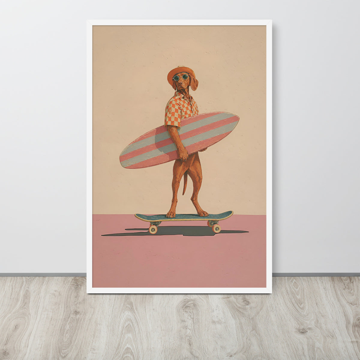 Vintage vizsla wall art print leaning against a white wall on a light wood floor. The print shows a stylized brown vizsla dog standing on a skateboard and holding a pink striped surfboard, with a beige background and a pink ground section.